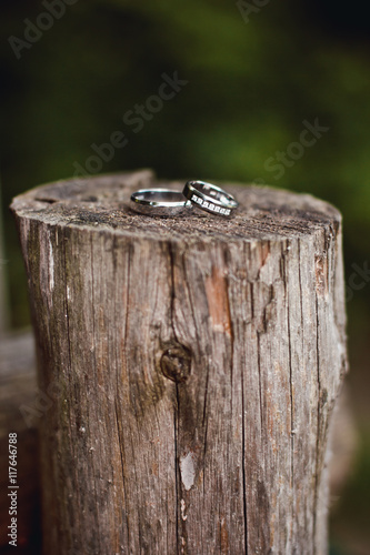 Beautiful engagement ring lie on wooden stand