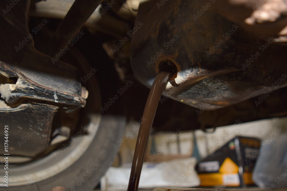 Drain the old oil from the engine through the drain plug Drain the old oil from the engine through the drain plug