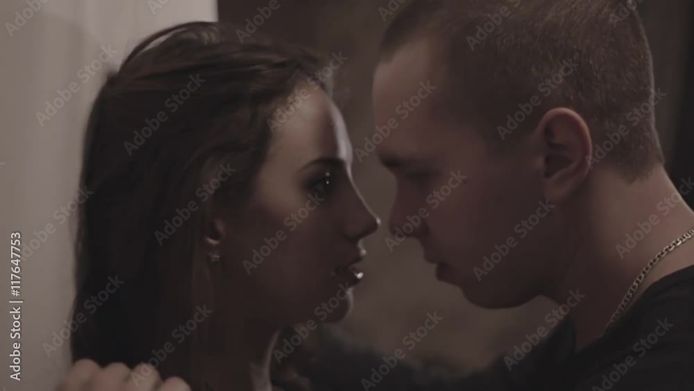 A man pushes a woman against a wall and want to kiss her A man pushes a woman against a wall and want to kiss her