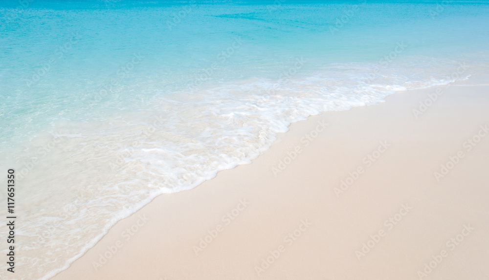 Tropical beach with coral white sand and calm wave Tropical beach with coral white sand and calm wave