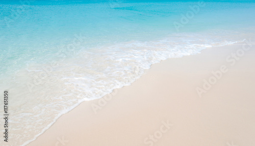 Tropical beach with coral white sand and calm wave