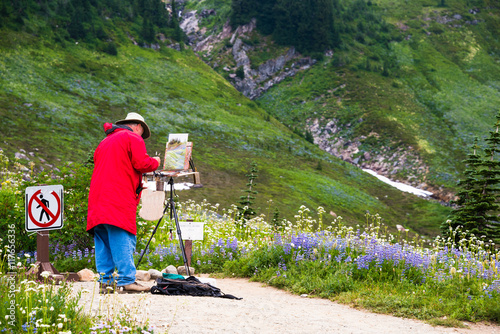 Senior Male Artist Painting on Easel Mountains & WIldflowers en Plein Air