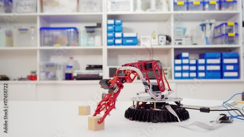 Experiment with intelligent manipulator. industrial robot model. Robot with optical recognition system