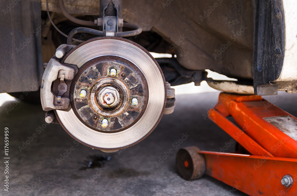 Car jack to lifting the car for replace wheel and repair at gara Car jack to lifting the car for replace wheel and repair at gara