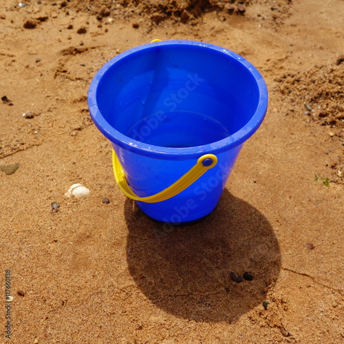 Blue Plastic Bucket on Beach