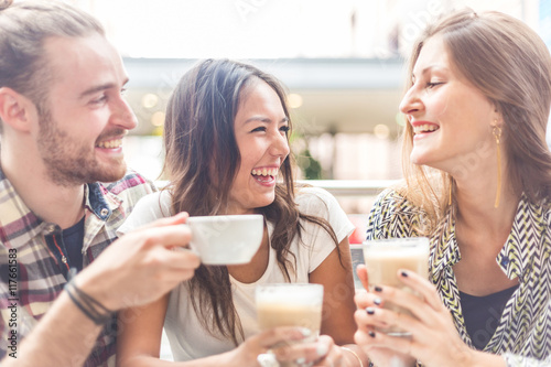 Multiracial group of friends having a coffee together