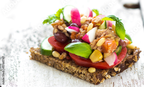 Delicious healthy sandwich with crunchy wholemeal bread on a wooden background