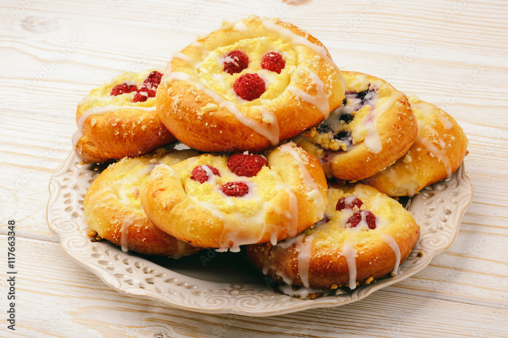 Fresh yeast buns with cheese and berries.