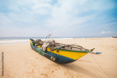 Traditional fishing boat on the beach. Shot in Sri Lanka.