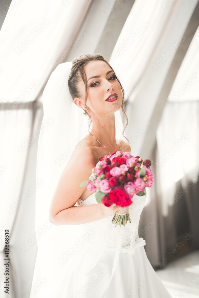 Luxury wedding bride, girl posing and smiling with bouquet Luxury wedding bride, girl posing and smiling with bouquet