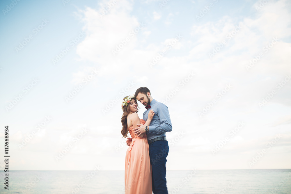 Wedding couple, bride, groom walking and posing on pier