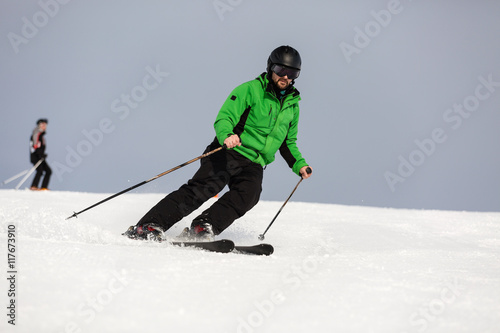 Male skier skiing on ski slope