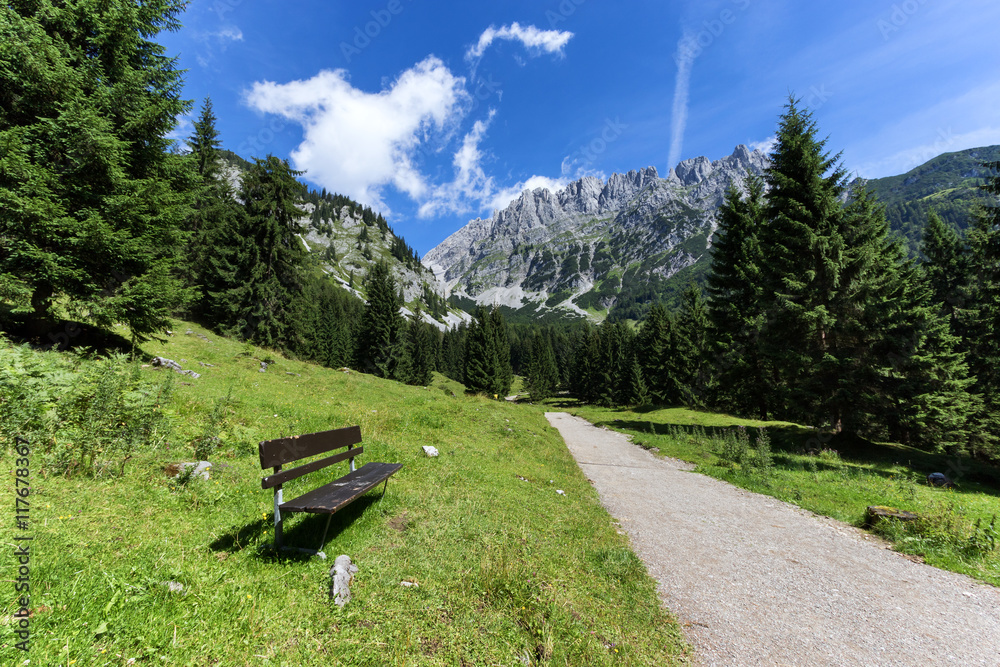 Idyllic mountain scene with a bench in the foreground.  Austrian alps, Tyrol, Wilder Kaiser