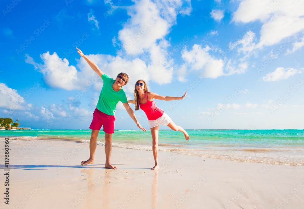 picture of happy couple in sunglasses on the beach picture of happy couple in sunglasses on the beach
