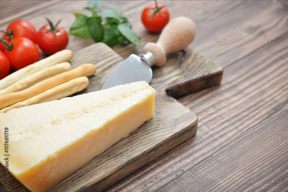 Parmesan cheese on cutting board Parmesan cheese on cutting board