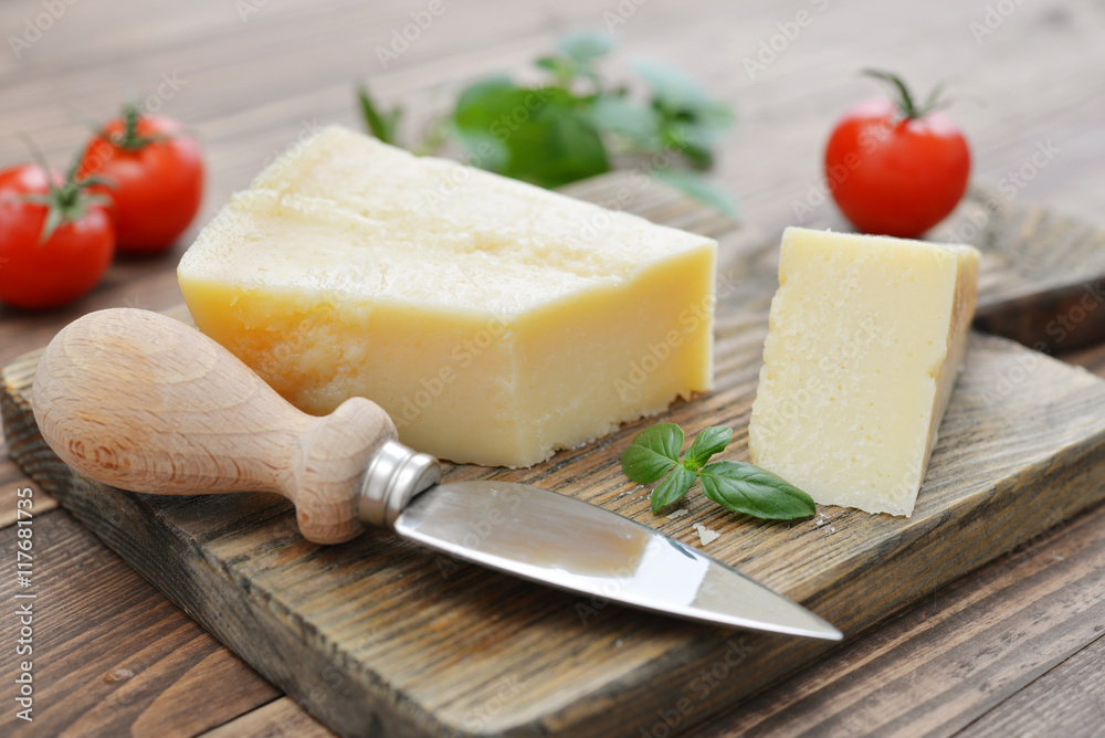 Parmesan cheese on cutting board Parmesan cheese on cutting board
