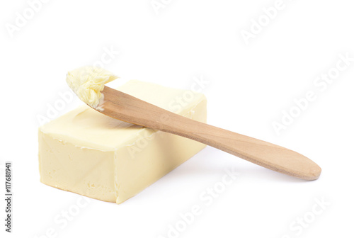 Knife over a piece of butter isolated photo