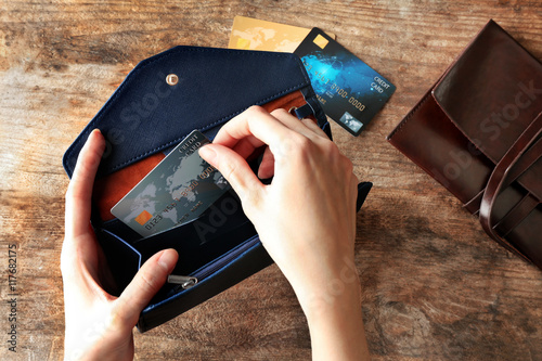 Woman taking credit card of...