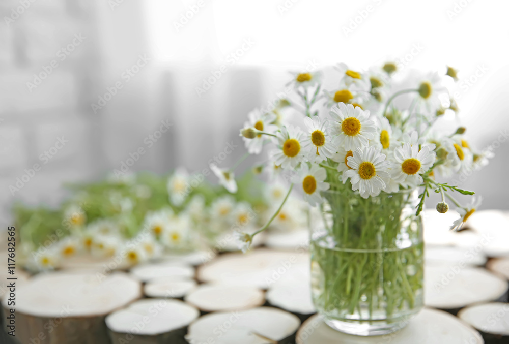 Chamomile bouquet on wooden table