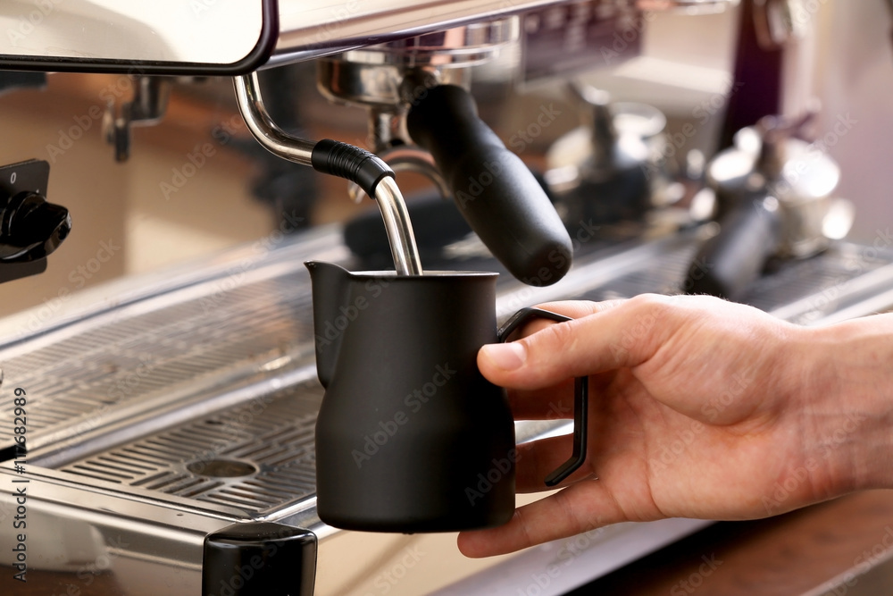 Barista whipping milk in coffee machine Barista whipping milk in coffee machine