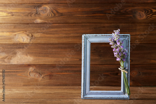 Lavender with frame on wooden background