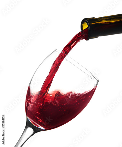 Red wine pouring into wine glass, isolated on white