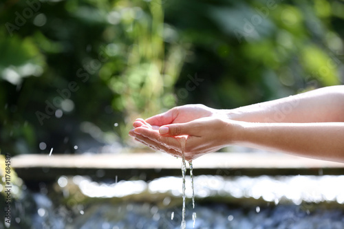 Water dropping from woman's hands