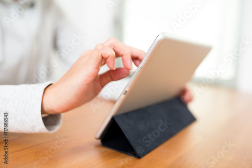 Woman using tablet computer at home