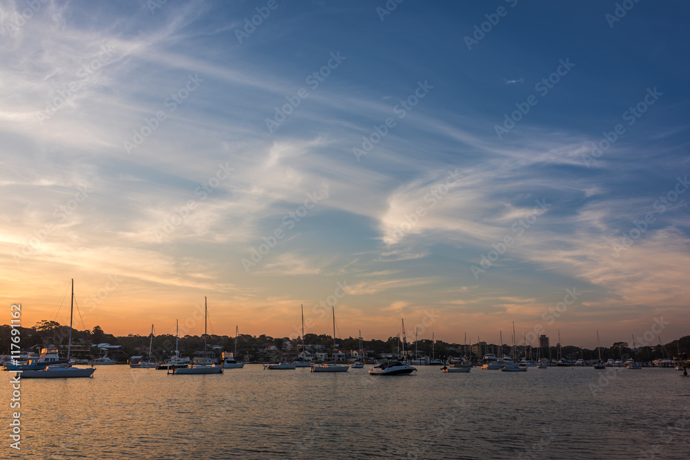 Beautiful Gunnamatta Bay sunset view with sailboats, yachts and motorboats. Harbour lifestyle scene