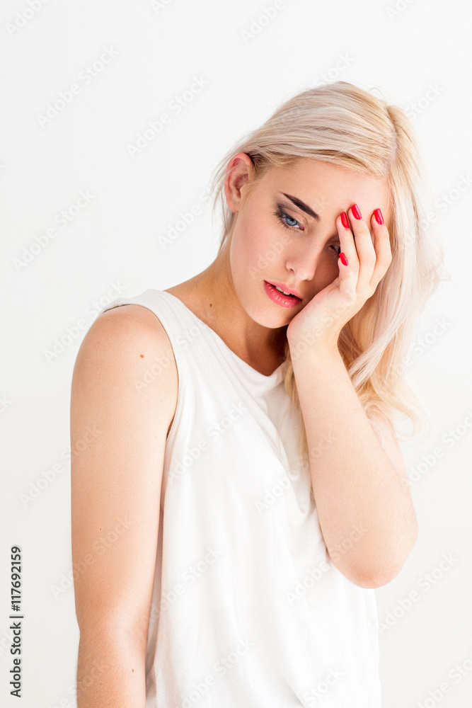Attractive blonde woman with headache. Young female put palm on her head. Migraine, tiredness, frustration concept Attractive blonde woman with headache. Young female put palm on her head. Migraine, tiredness, frustration concept