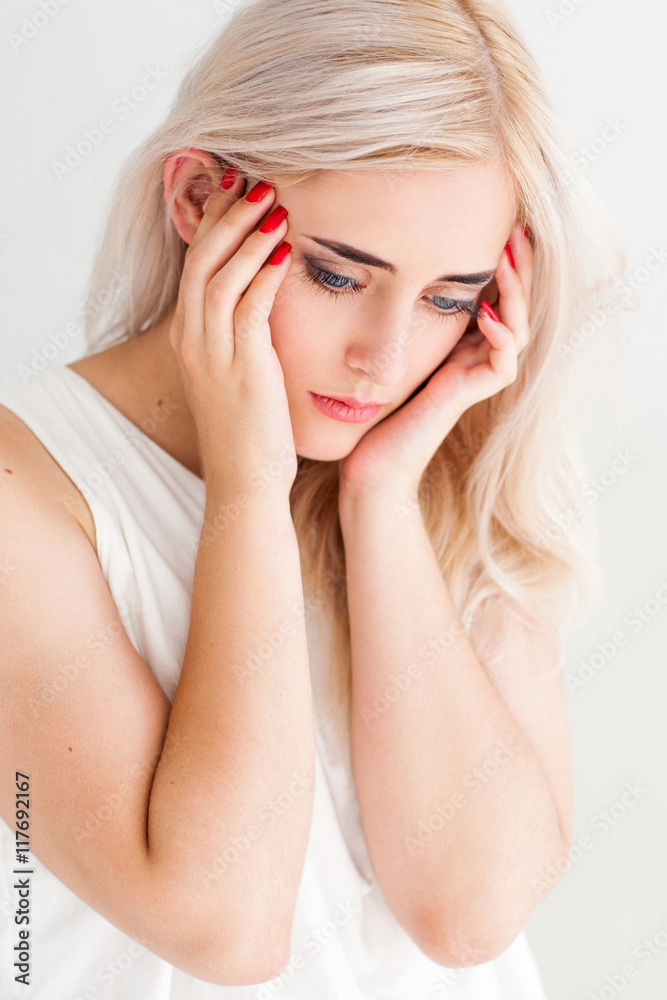Strong migraine concept. Poor beautiful blonde woman with severe headache, close-up on white background Strong migraine concept. Poor beautiful blonde woman with severe headache, close-up on white background