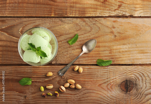 Fototapeta Naklejka Na Ścianę i Meble -  pistachio ice cream with mint leaves and pistachio nuts