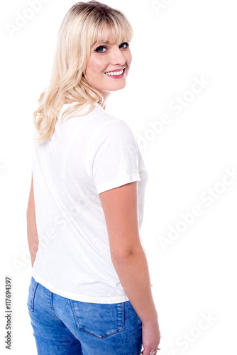 Smiling young pretty woman turning back photo