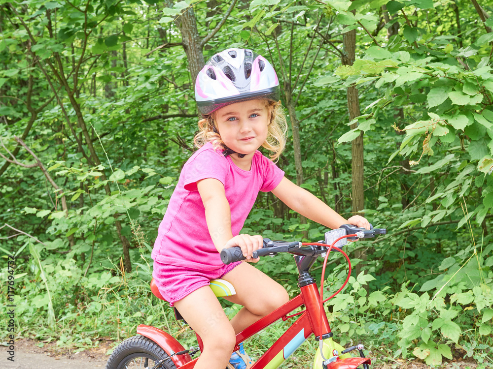 Happy child riding a bike in outdoor. Happy child riding a bike in outdoor.
