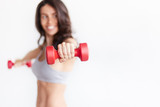 sporty woman hands with light red dumbbells