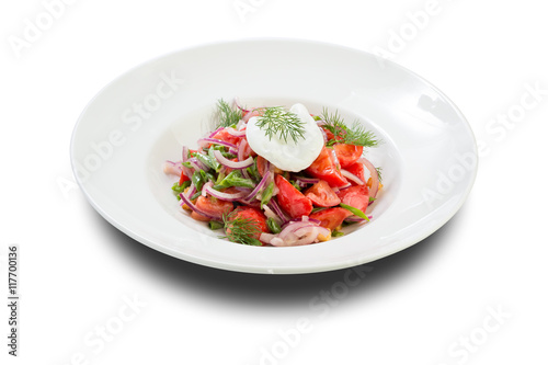 vegetable salad with poached egg tomato and dill on a white plate and a white background
