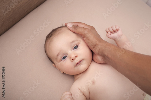 Interracial father calming his baby