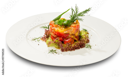 Vegetable stew on lettuce leaves. On a white plate and a white background