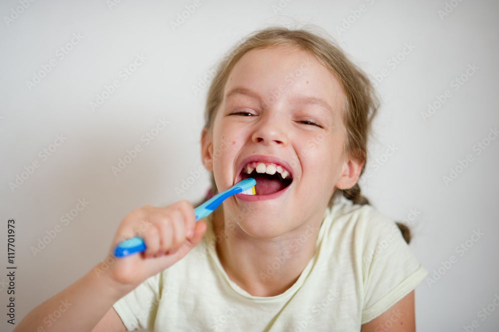 Cute little girl with pigtails diligently brushing his teeth. Cute little girl with pigtails diligently brushing his teeth.