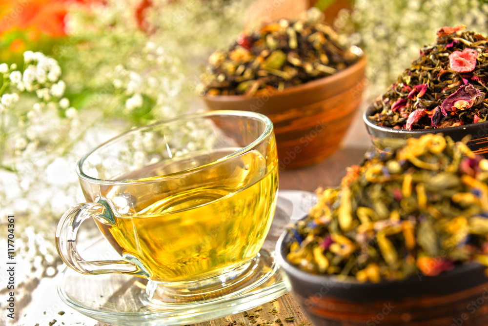 Composition with cup of tea and bowls of tea leaves