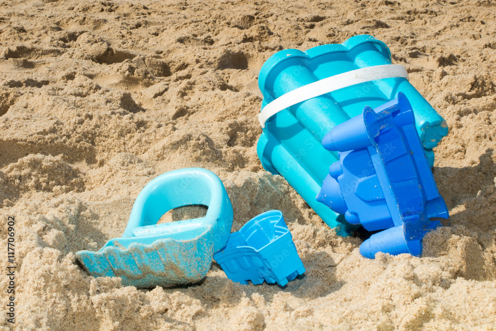 Beach toys in the sand summertime holidays at the sea Beach toys in the sand summertime holidays at the sea