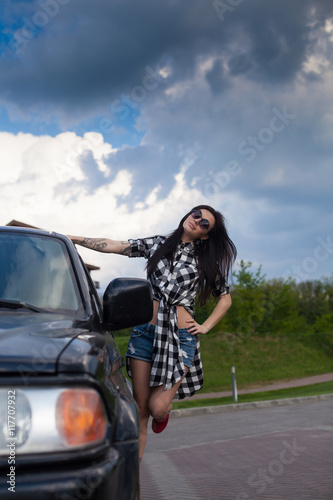 The woman is near a car © Dmitry Bairachnyi