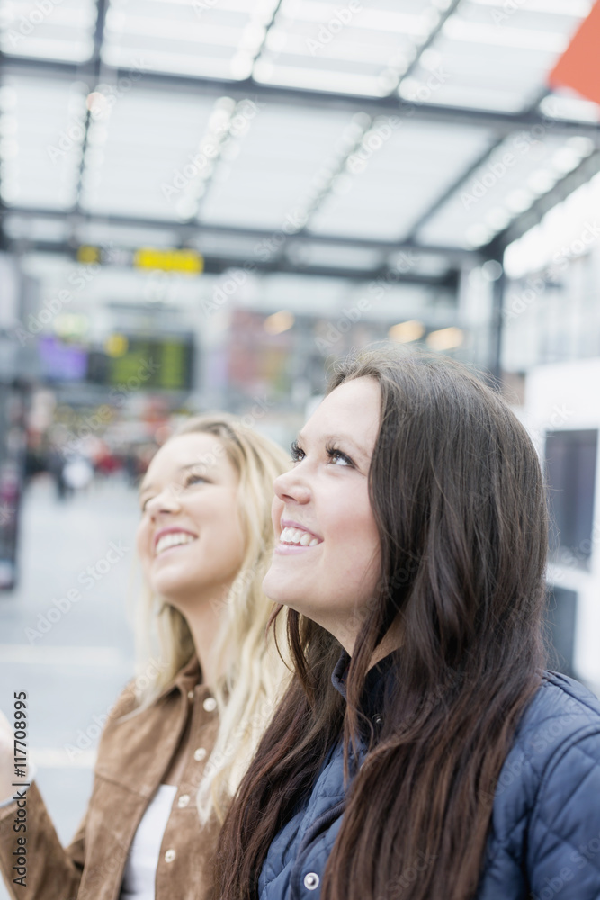 custom made wallpaper toronto digitalHappy female friends looking away at railway station
