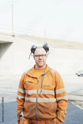 Portrait of confident manual worker at road construction site photo