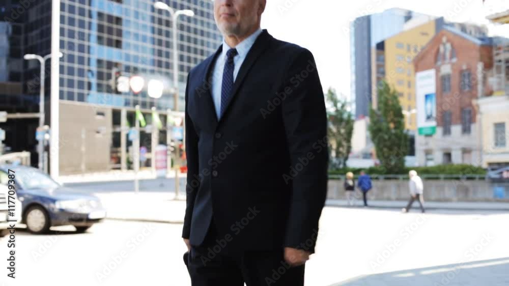 senior businessman walking with travel bag in city senior businessman walking with travel bag in city