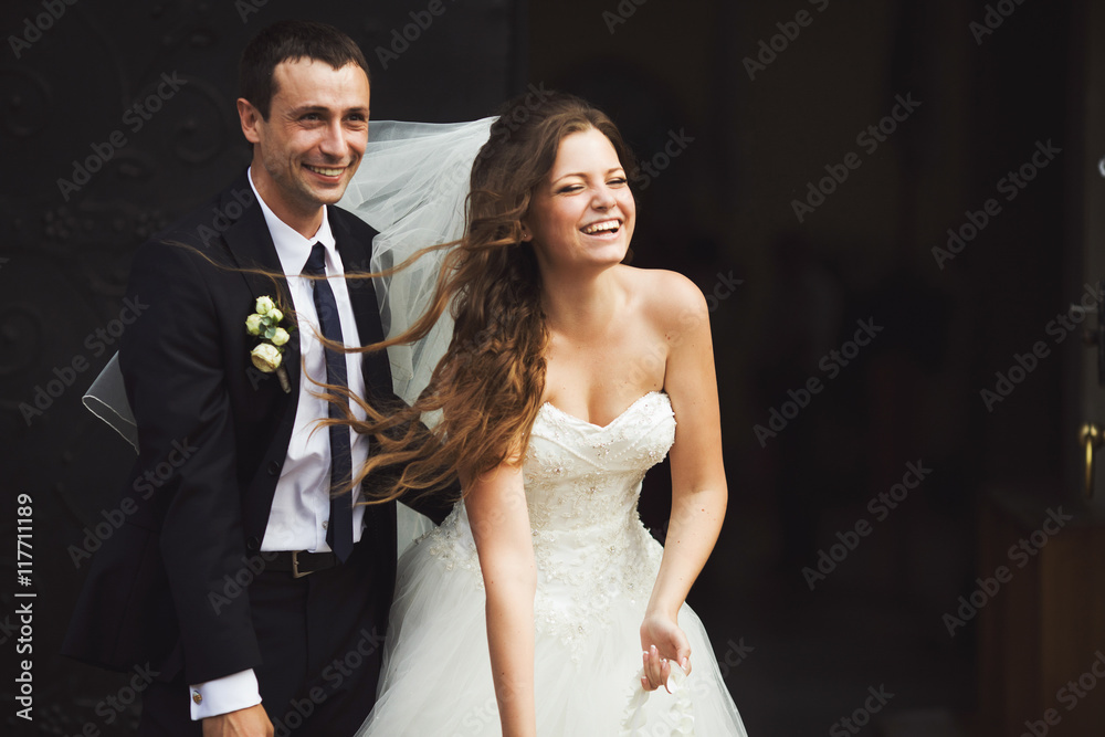 Wind blows bride's hair while she throws sweets to the guests Wind blows bride's hair while she throws sweets to the guests