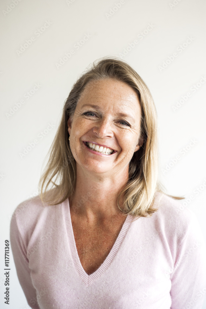 Portrait of smiling mature female teacher in classroom Portrait of smiling mature female teacher in classroom