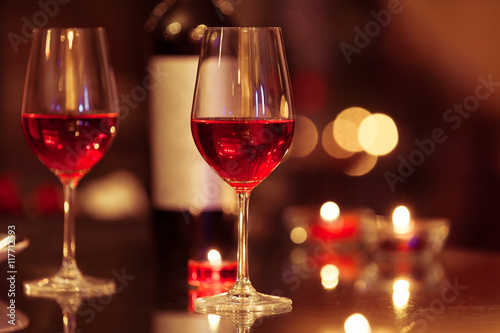 Wine glasses in a romantic setting. 