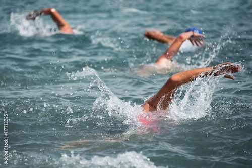 Group of swimmers swim in the sea at the races in triathlon © pavel1964