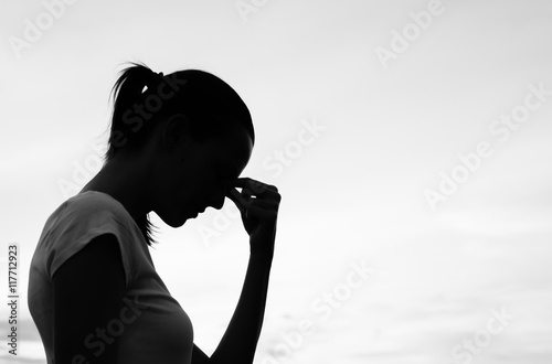 Silhouette of a tired and stressed woman. 